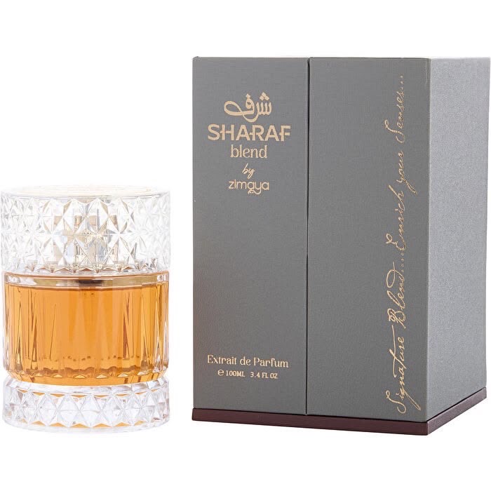 Diamond-cut crystal fragrance bottle with amber liquid beside charcoal packaging